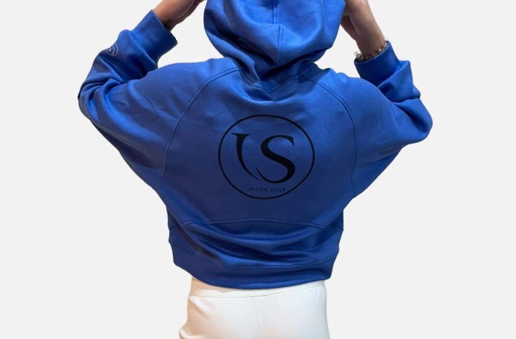 A person wearing a blue hoodie with the letter s on it.