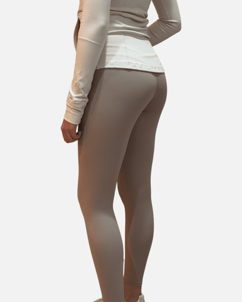 A woman in tight pants and white shirt.